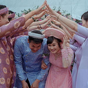  A group of people with their hands interlocked, forming a circle.