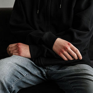 Man holding woman's hand tightly, suggesting coercion in signing premarital agreement