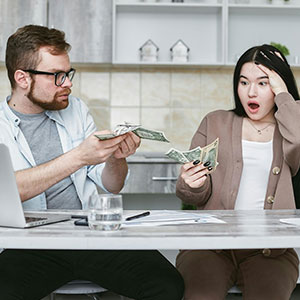 Couple arguing over financial documents during premarital agreement disclosure review